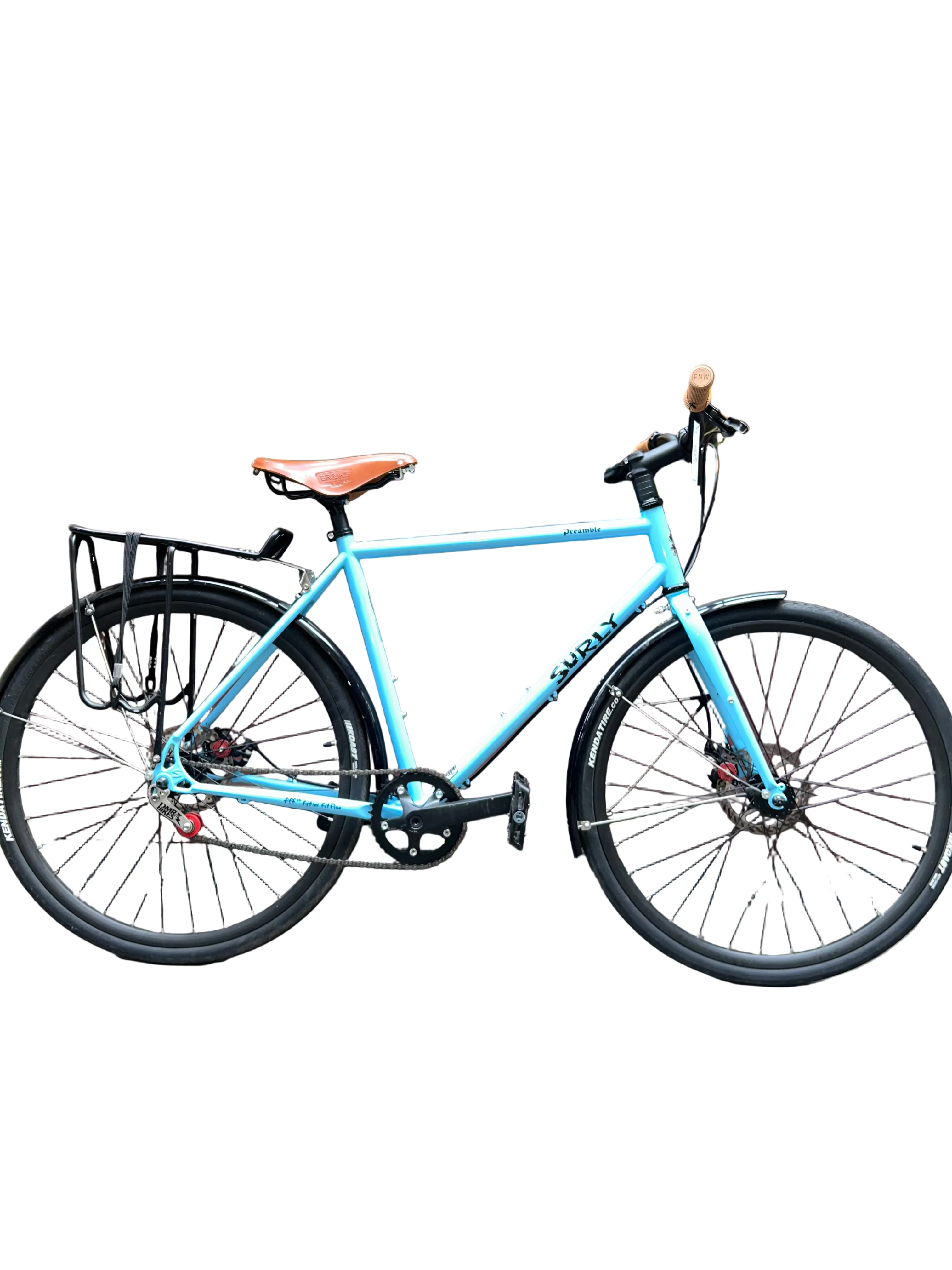 Blue bicycle parked on a sidewalk in front of a store window.