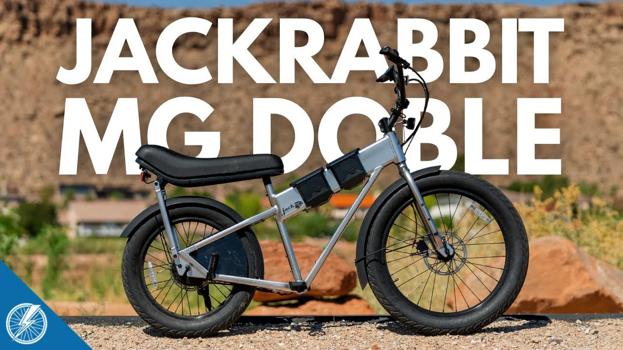 Fat-tire bike with 'Jackrabbit MG Doble' text against a desert background