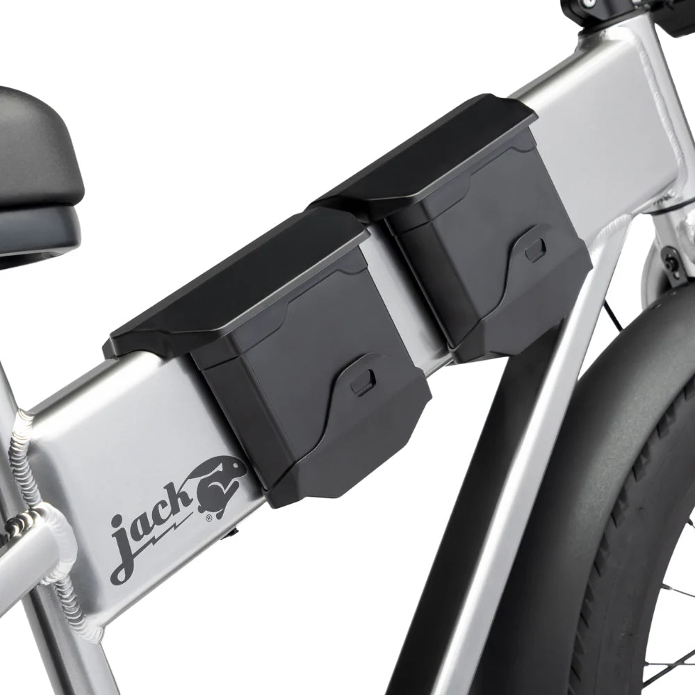Close-up of a bicycle with black storage boxes attached, featuring the brand 'jack'.