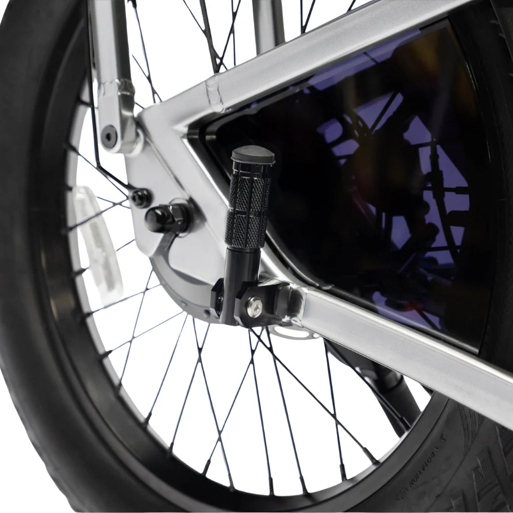 Close-up of a bicycle wheel with a smartphone mounted on a holder.