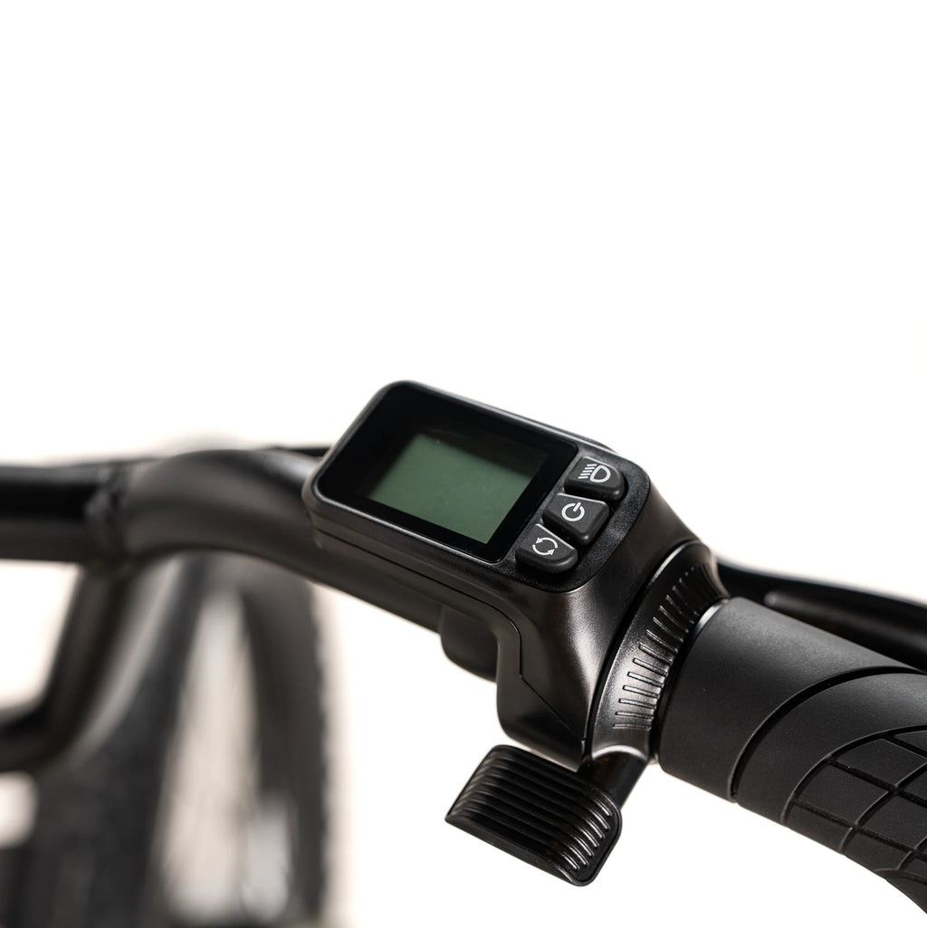 Close-up of a black electronic device on a handlebar with a blurred background