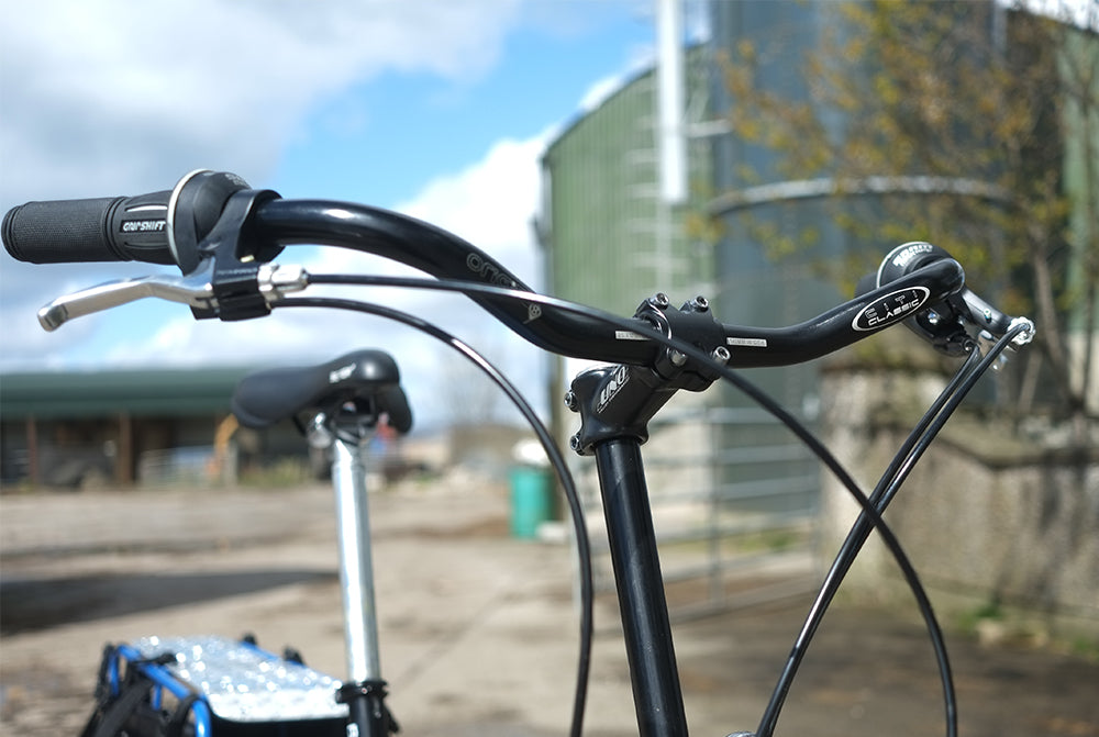 Close-up of bicycle handlebars with blurred background