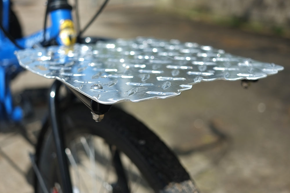 Metal bike rack on a bicycle with a blurred background