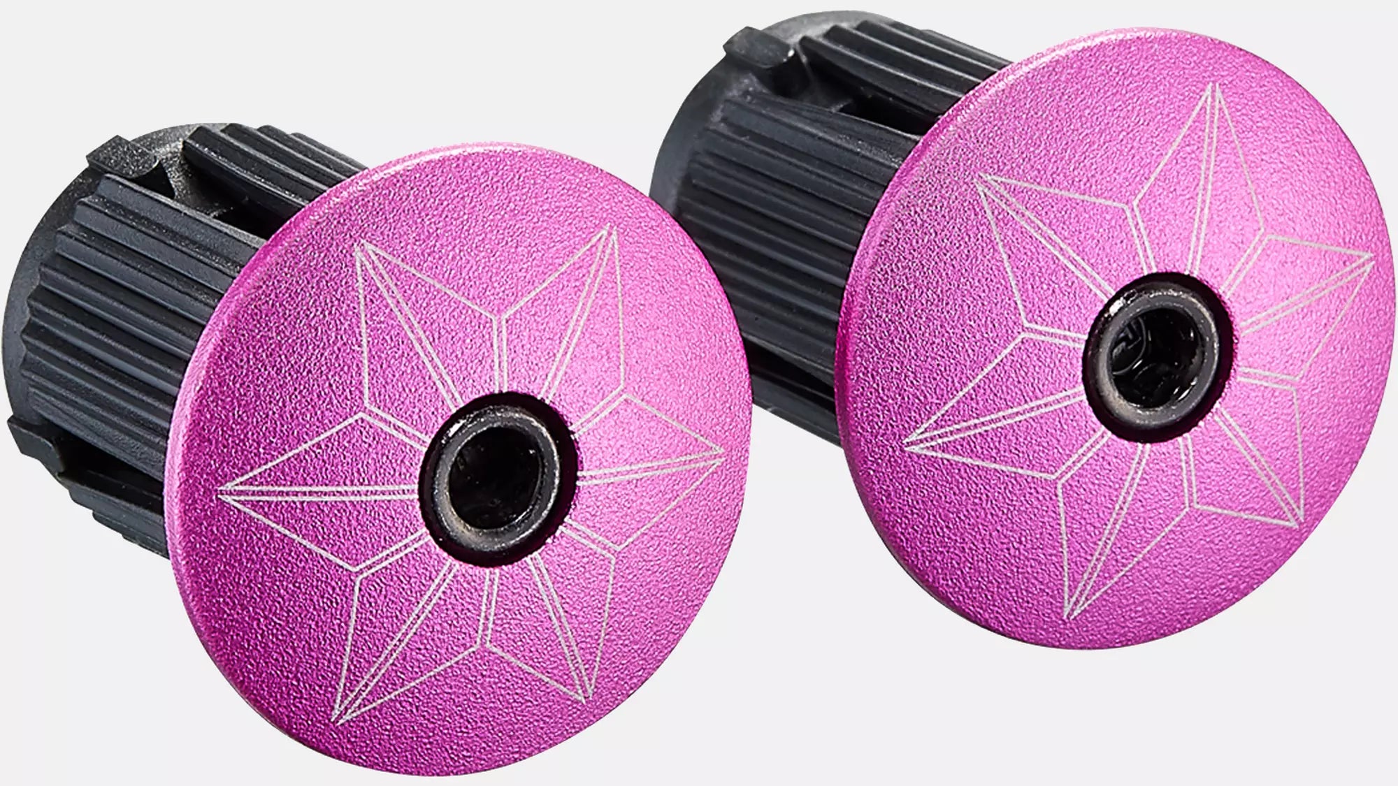 Two pink wheel bearings with black centers on a white background