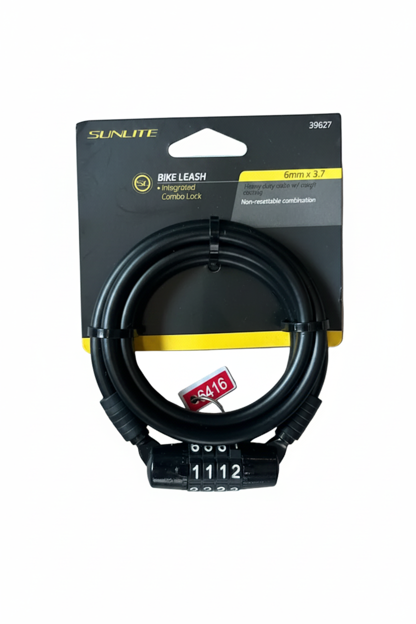 A black Sunlite bike leash with a combination lock and integrated cord lock, packaged on its original black and yellow cardboard backing, placed on a gray wood plank surface.