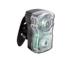 A bicycle clip-on rear light with a black plastic clip and a clear plastic housing showing green-tinted internal components, set against a plain white background.