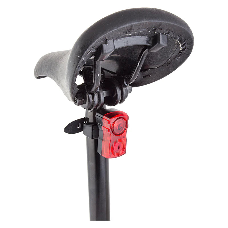 Bicycle rear light attached to a black stand on a white background