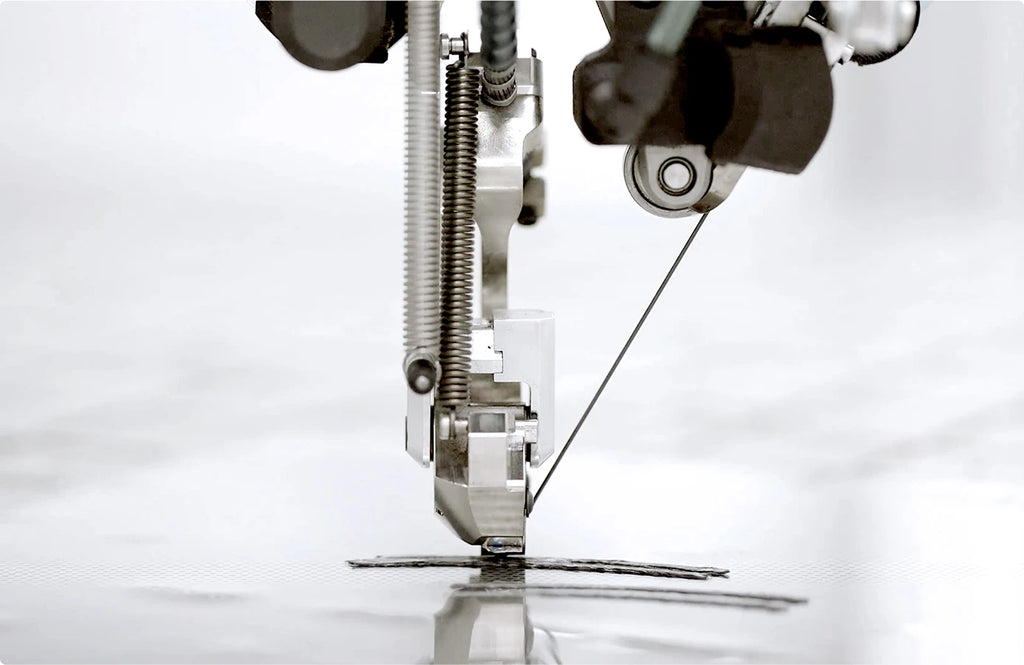 Close-up of a sewing machine needle and thread on a white background