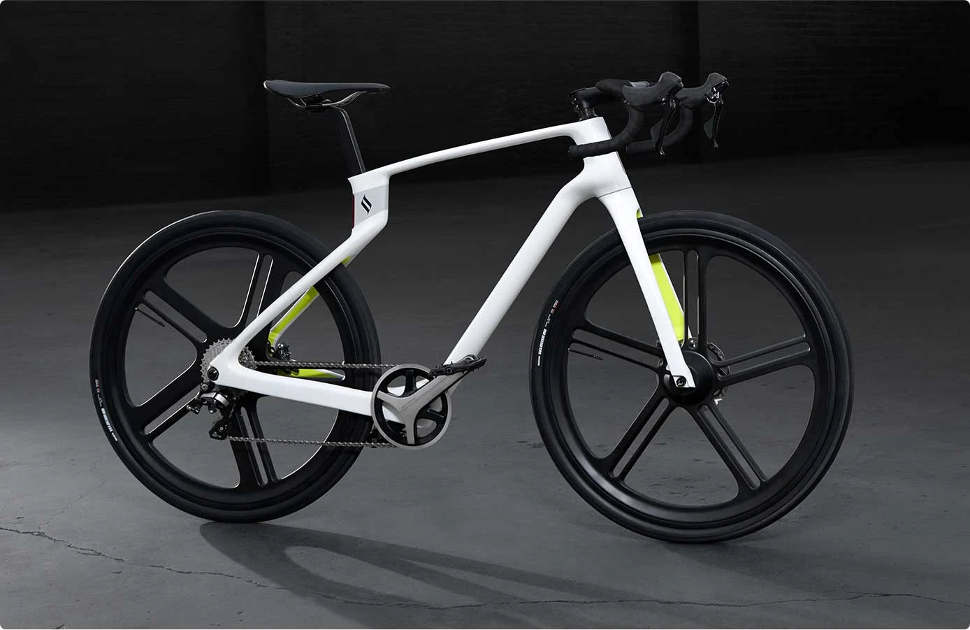 White bicycle with black tires on a dark background