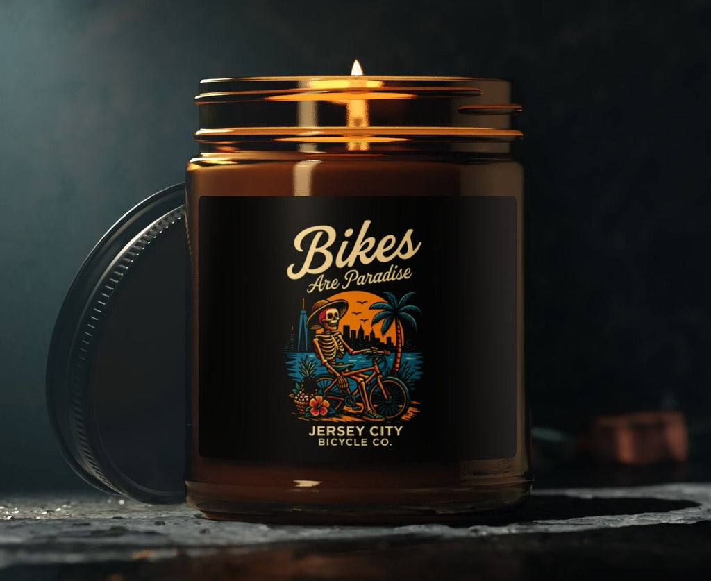 Candle in a jar with 'Bikes Are Paradise' label on a dark background 