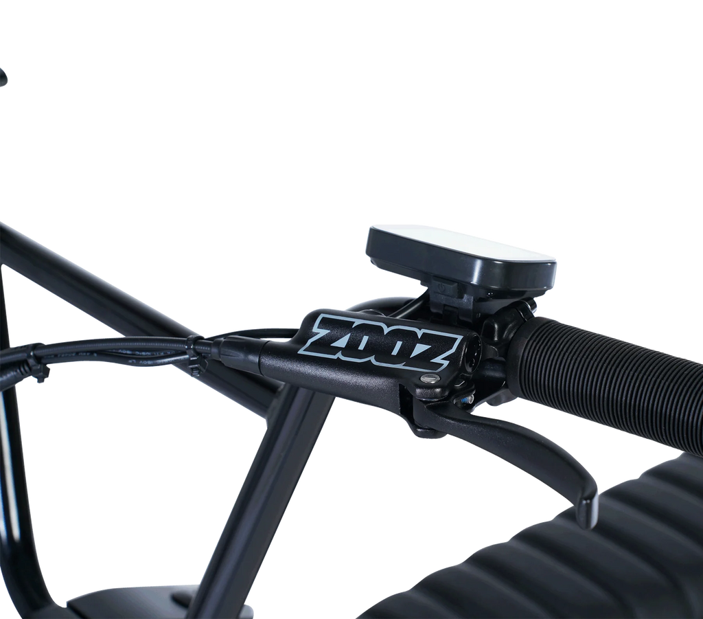 Close-up of a bicycle handlebar with a Zoonz device attached on a white background
