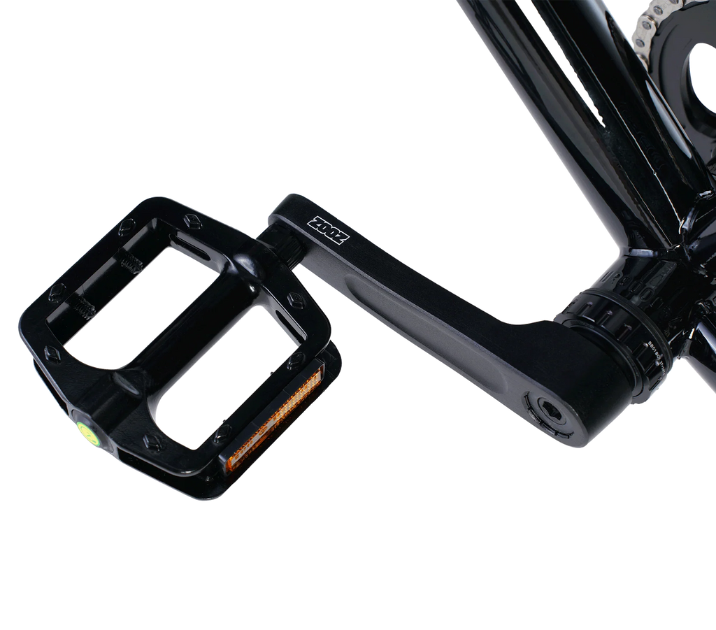 Close-up of a black bicycle pedal with a white background
