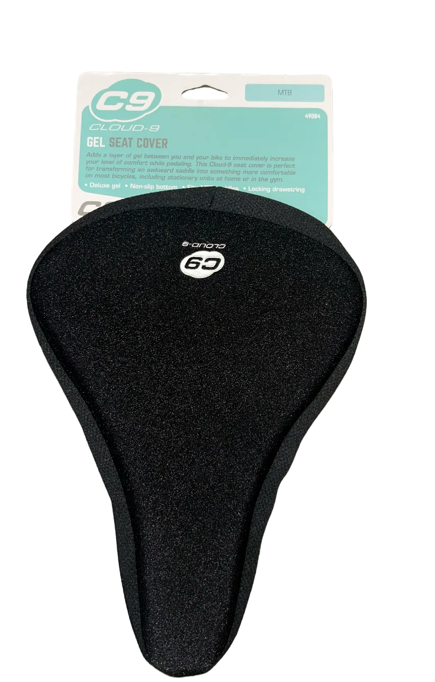 A black C9 Cloud 3 gel seat cover for bicycles, shown with its original retail packaging card on a gray wood-plank floor.