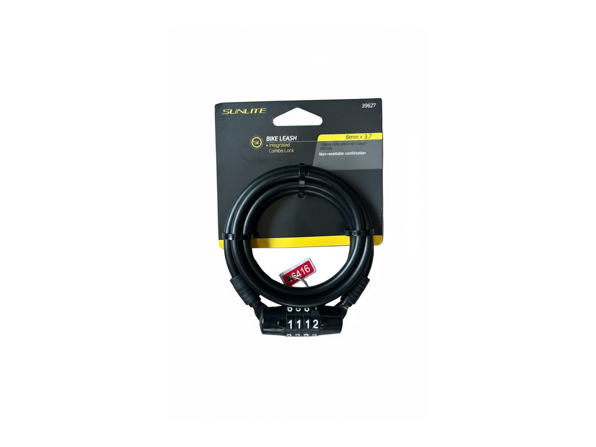 A black Sunlite bike leash with a combination lock and integrated cord lock, packaged on its original black and yellow cardboard backing, placed on a gray wood plank surface.