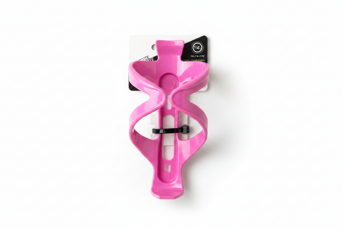 A bright pink bicycle water bottle cage mounted on a white and black retail hanger, placed on a weathered gray-brown wooden plank surface.